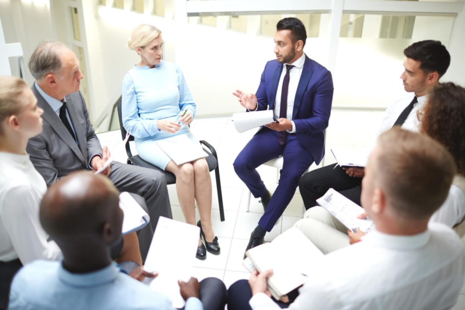 Business consultant facilitating financial planning workshop with diverse team